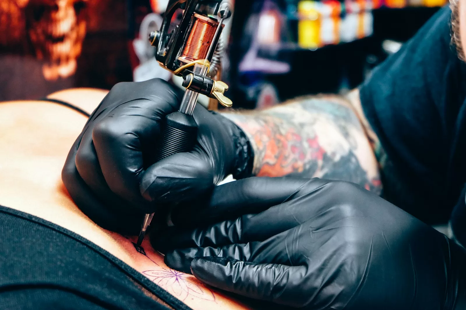 Best Tattoo Kits in India for Beginners Explained A man with a tattoo on his arm holding a gun