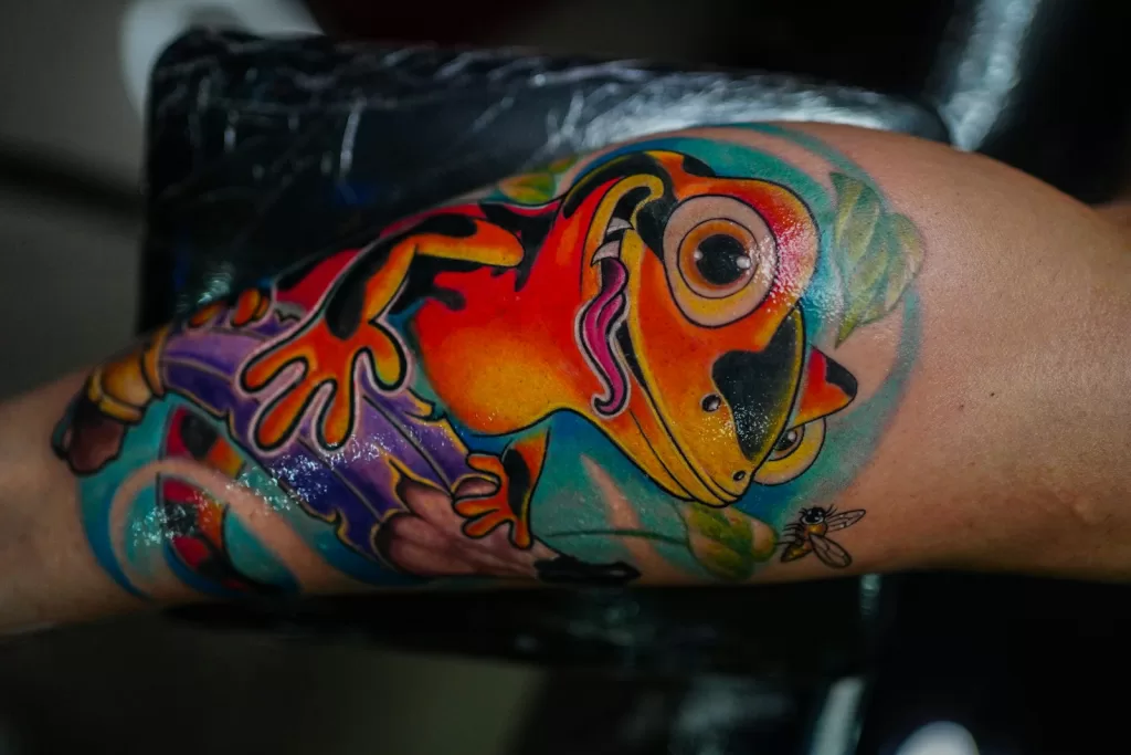 Best Tattoo Inks in India: The Ultimate Artist's Buying Guide a colorful tattoo of a frog on the arm