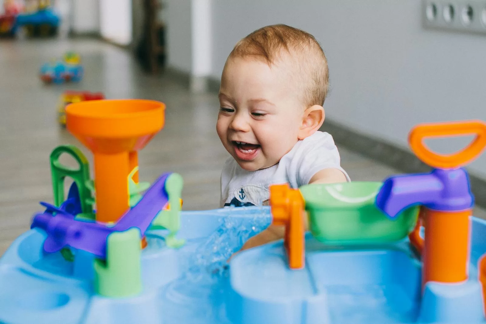 Best Baby Walkers in India: 5 Safe Picks for First Steps & Indoor Play happy baby playing with a colorful indoor toy showing the kind of care and cleaning routine the best baby walker in India needs at home
